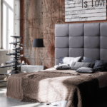 Cabecero Rembrandt de Marpe tapizado en gris con diseño acolchado en dormitorio de estilo industrial